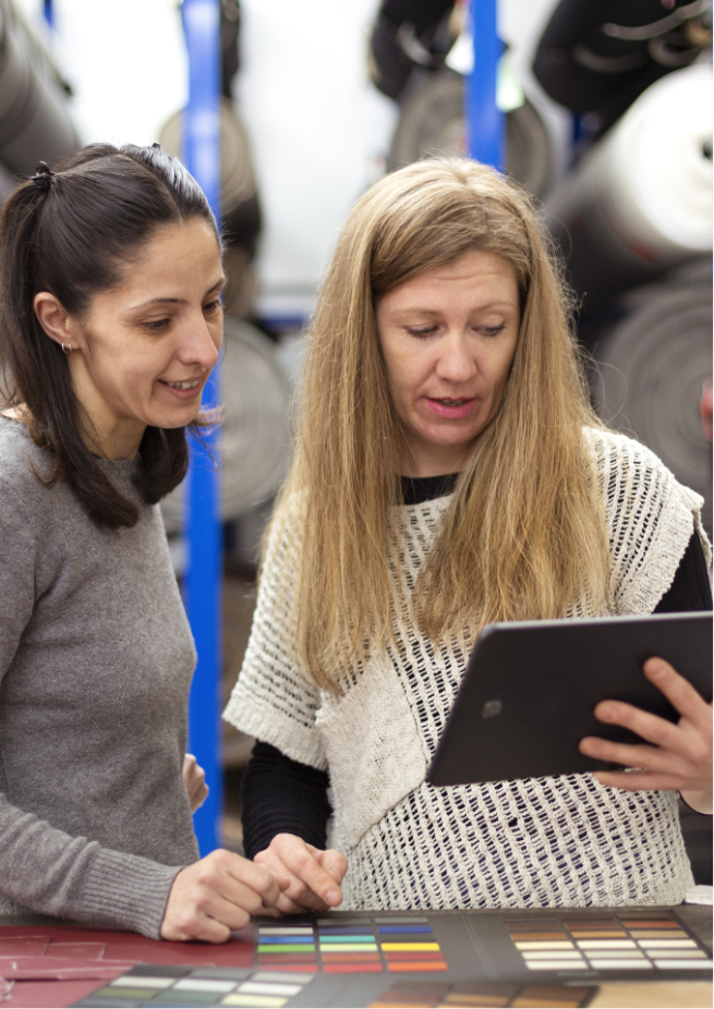 female-coworkers-are-looking-something-digital-tablet